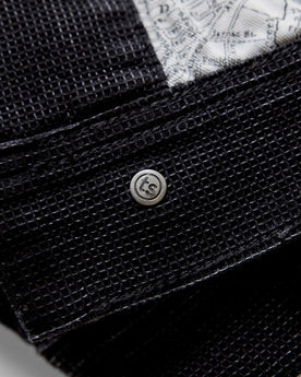 material shot of the inner button on The Long Haul Jacket in Black Indigo Waffle, Outerwear by Taylor Stitch