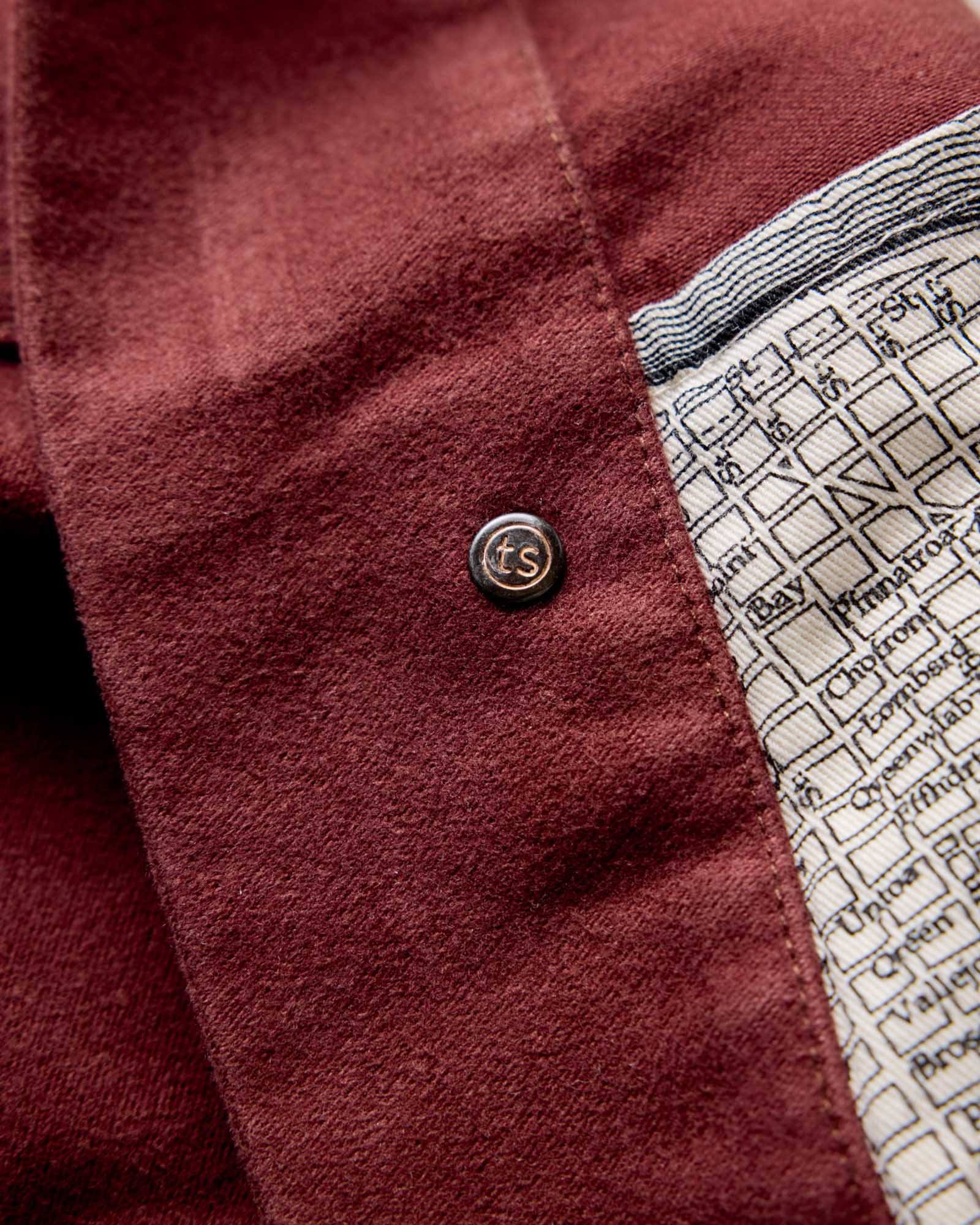 material shot of the inner button on The Long Haul Jacket in Dried Cherry Moleskin, Outerwear by Taylor Stitch