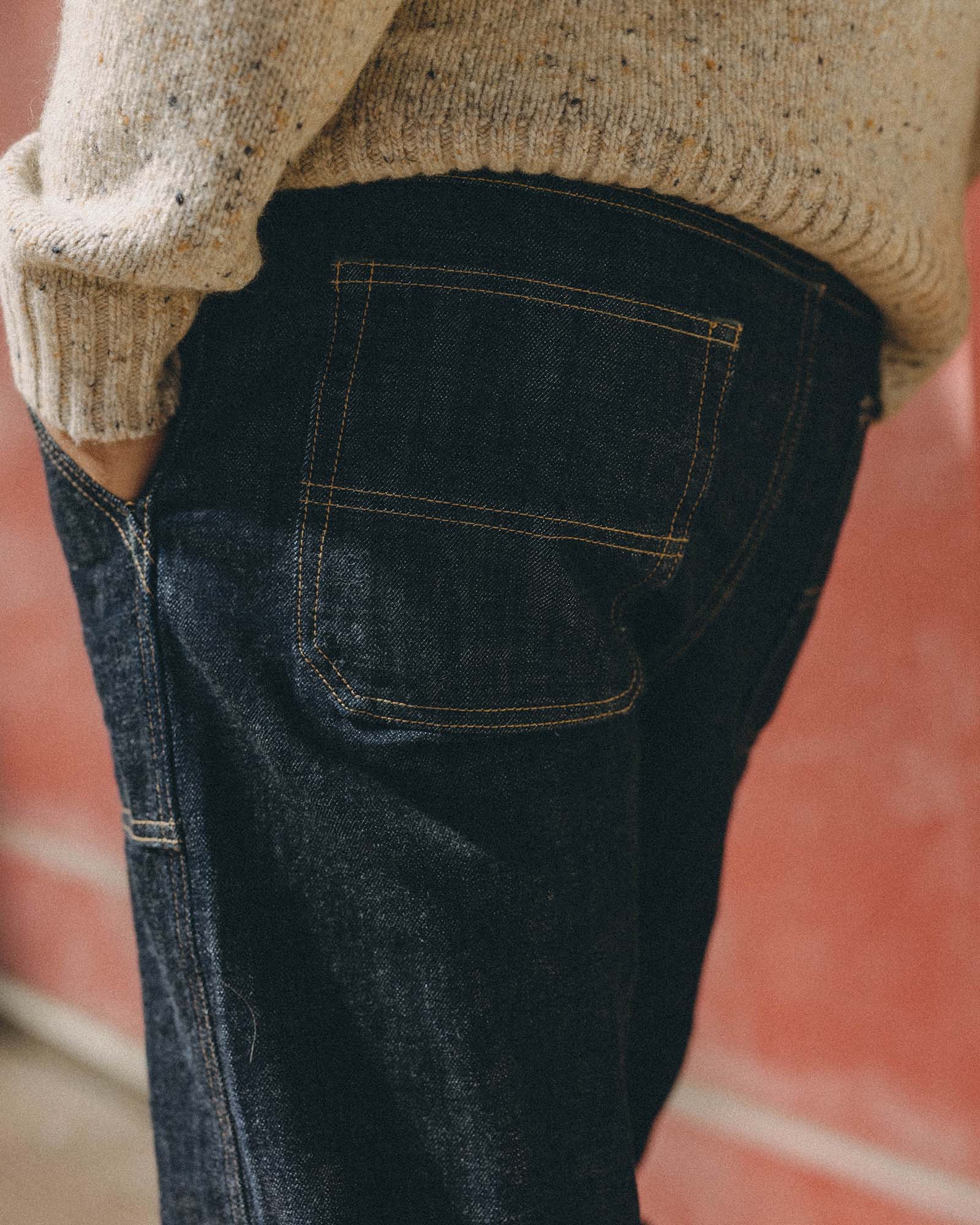 fit model with his hand in his pocket wearing The Mariner Jean in Rinse Organic Selvedge, Bottoms by Taylor Stitch