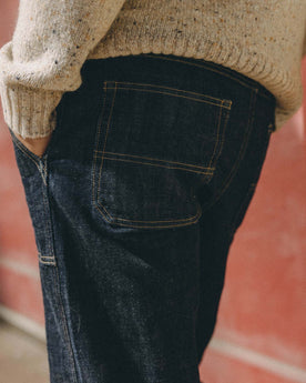 fit model with his hand in his pocket wearing The Mariner Jean in Rinse Organic Selvedge, Bottoms by Taylor Stitch