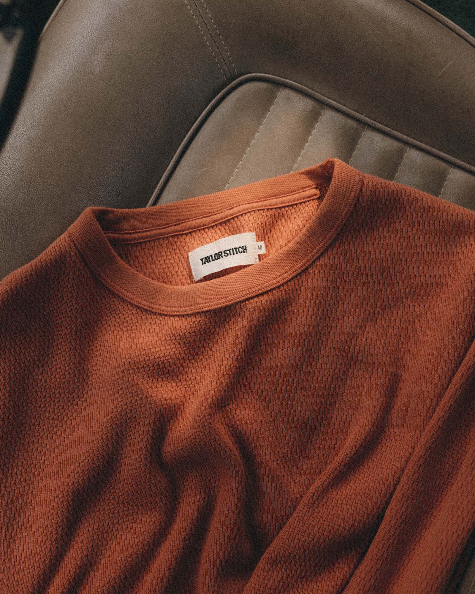 editorial flatlay of The Organic Cotton Crew in Summit Orange Waffle, Knits by Taylor Stitch