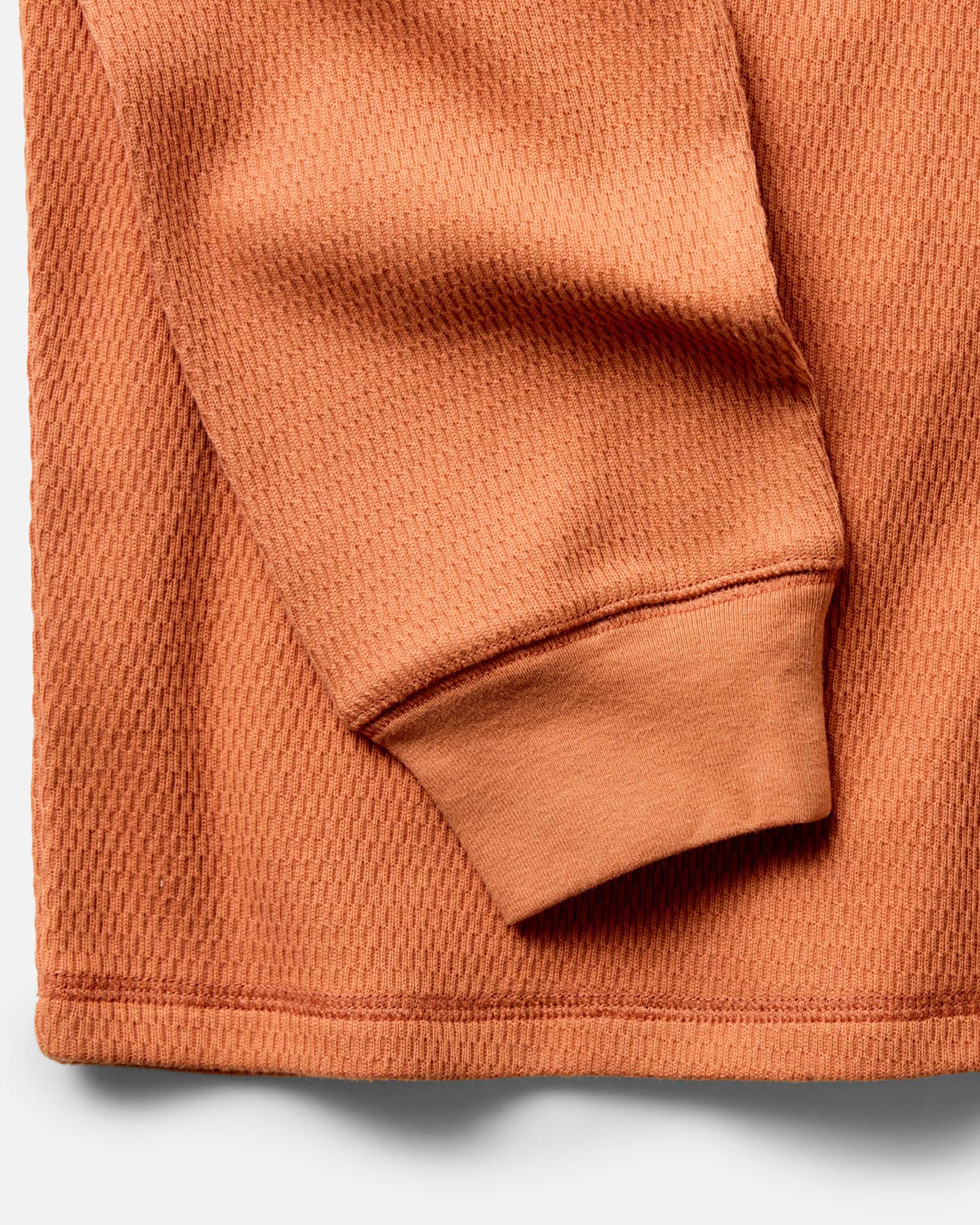 material shot of the sleeve on The Organic Cotton Crew in Summit Orange Waffle, Knits by Taylor Stitch