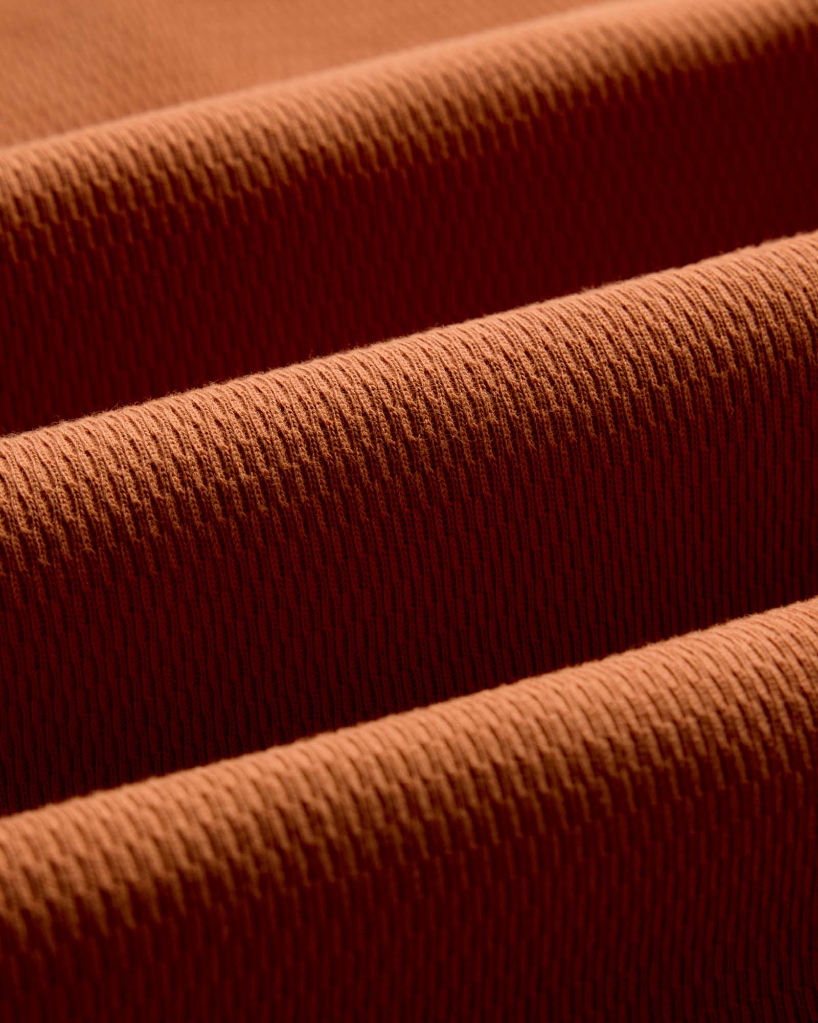 material shot of the fabric on The Organic Cotton Crew in Summit Orange Waffle, Knits by Taylor Stitch