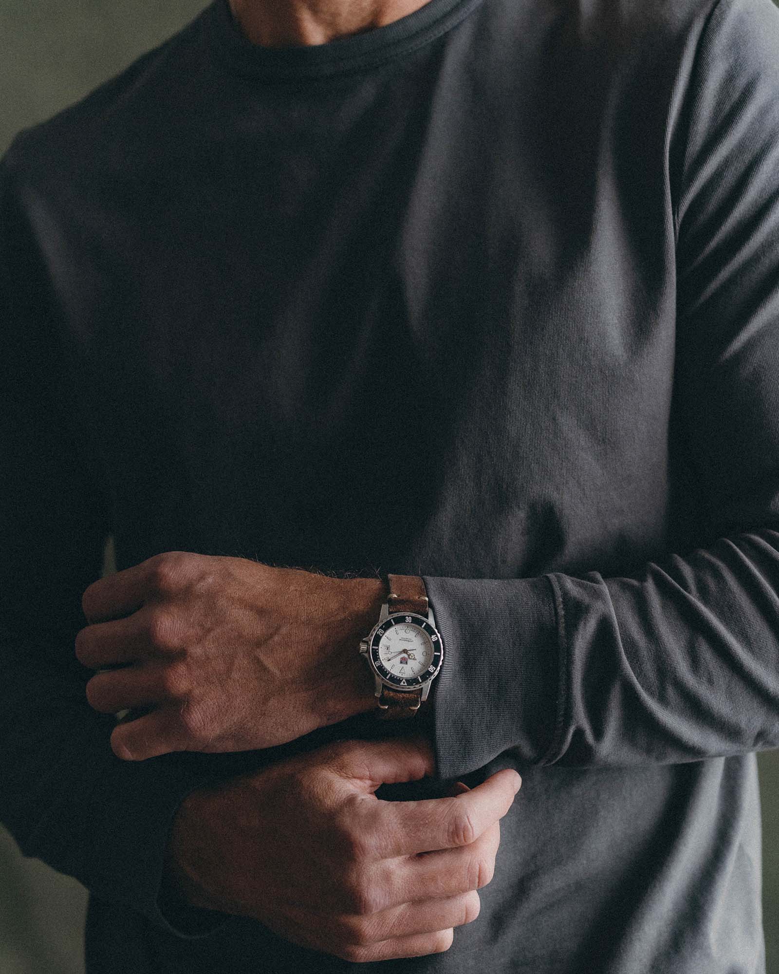 fit model adjusting the cuffs on The Organic Cotton Long Sleeve Tee in Faded Black, Knits by Taylor Stitch