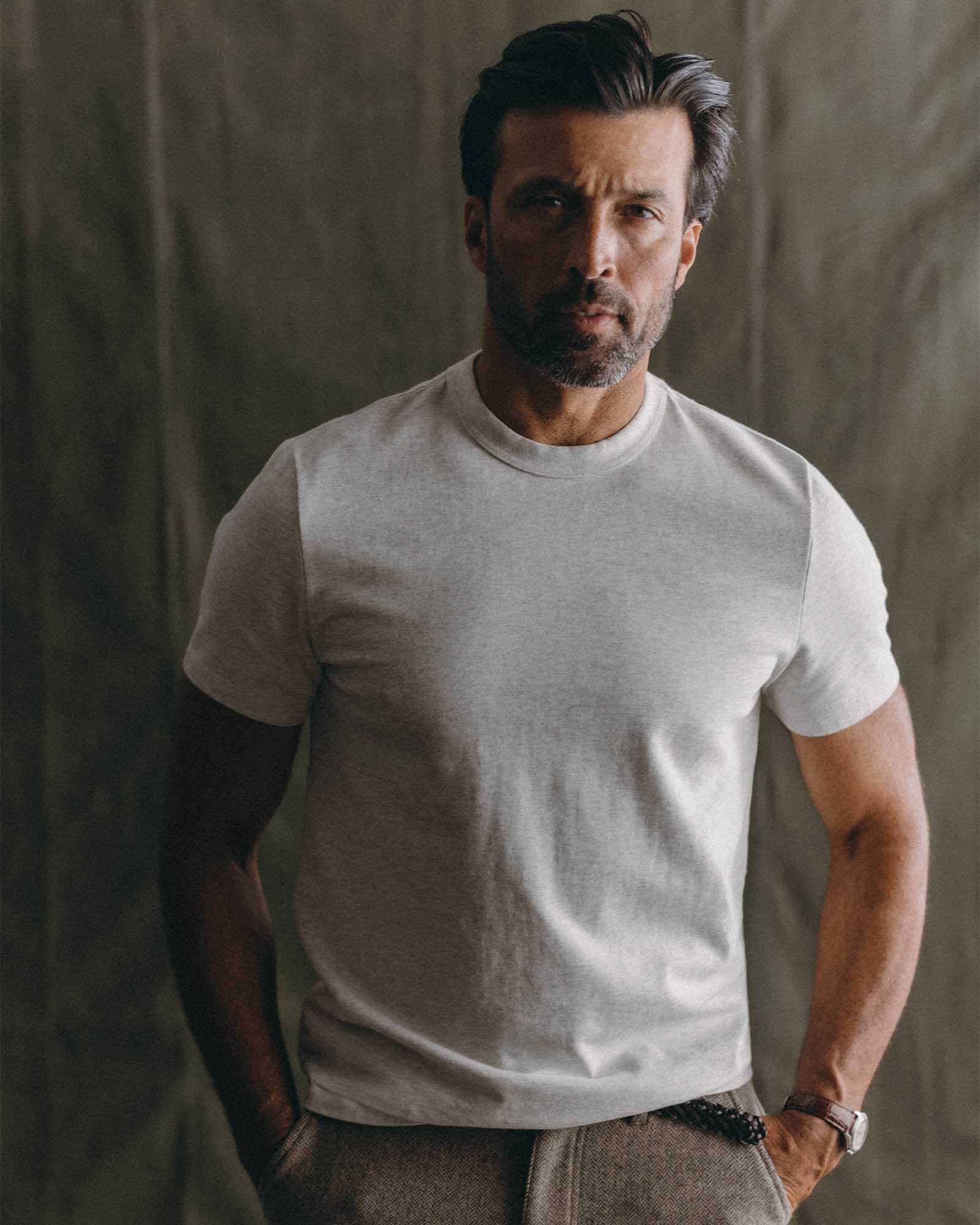 fit model leaning against the wall wearing The Organic Cotton Shop Tee in Oat Twist, Knits by Taylor Stitch