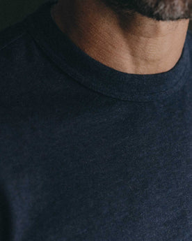 fit model with his hands folded wearing The Organic Cotton Shop Tee in Navy Twist, Knits by Taylor Stitch