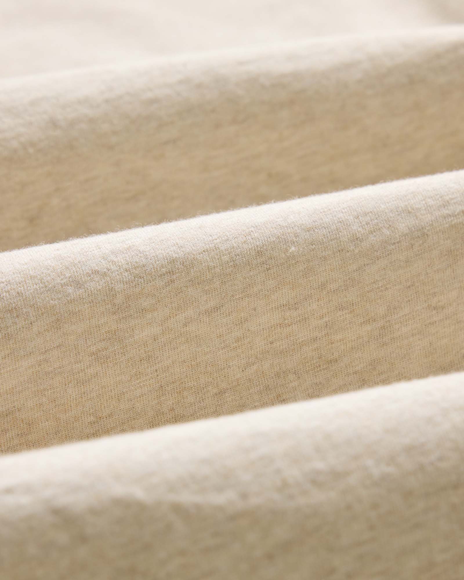 material shot of the fabric on The Organic Cotton Tee in Heather Oat, Knits by Taylor Stitch