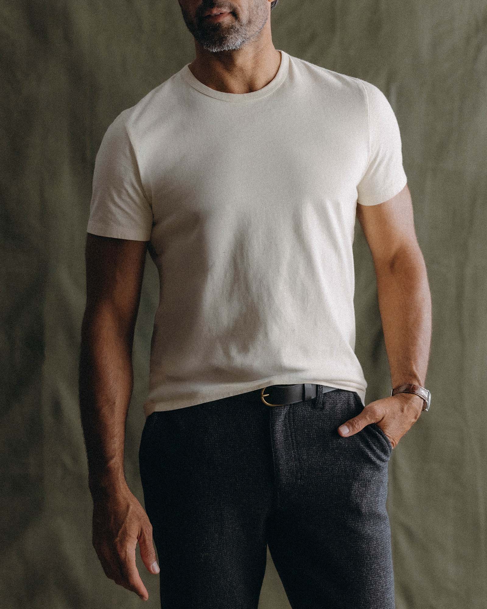 fit model walking wearing The Organic Cotton Tee in Vintage White, Knits by Taylor Stitch