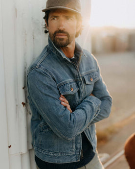 fit model leaning against the wall wearing The Roper Jacket in Vintage Wash Organic Selvedge, Outerwear by Taylor Stitch