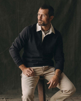 fit model posing in The Rugby Shirt in Coal, Knits by Taylor Stitch