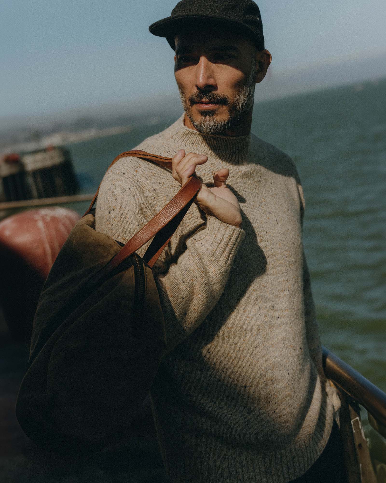 fit model posing in The Seafarer Sweater in Natural Donegal, Knits by Taylor Stitch