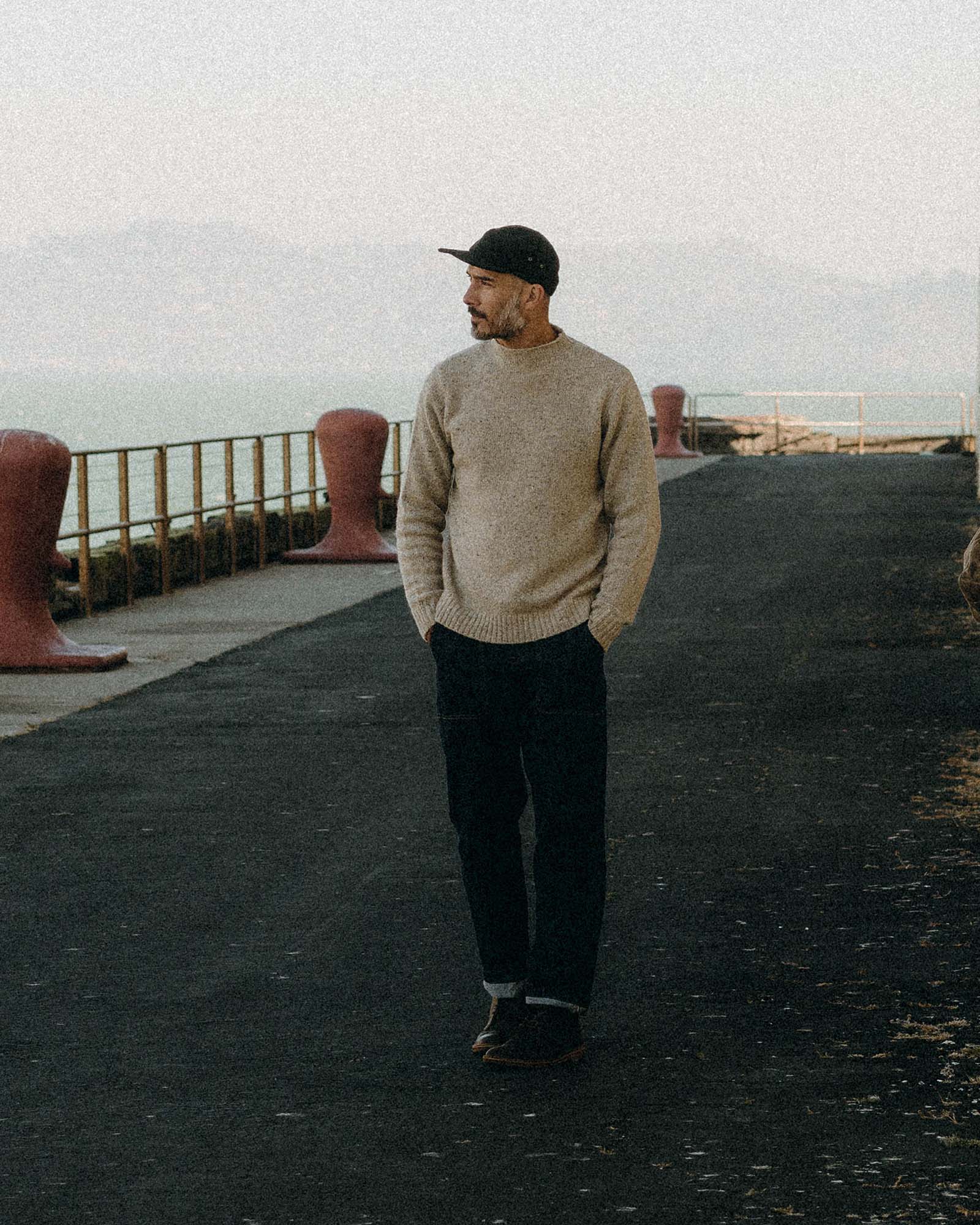 fit model walking wearing The Seafarer Sweater in Natural Donegal, Knits by Taylor Stitch