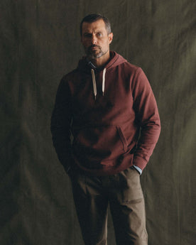 fit model posing in The Shop Hoodie in Dried Cherry, Knits by Taylor Stitch