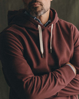 fit model showing off The Shop Hoodie in Dried Cherry, Knits by Taylor Stitch