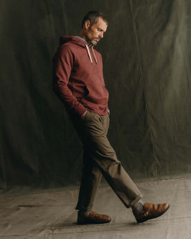 fit model walking wearing The Shop Hoodie in Dried Cherry, Knits by Taylor Stitch