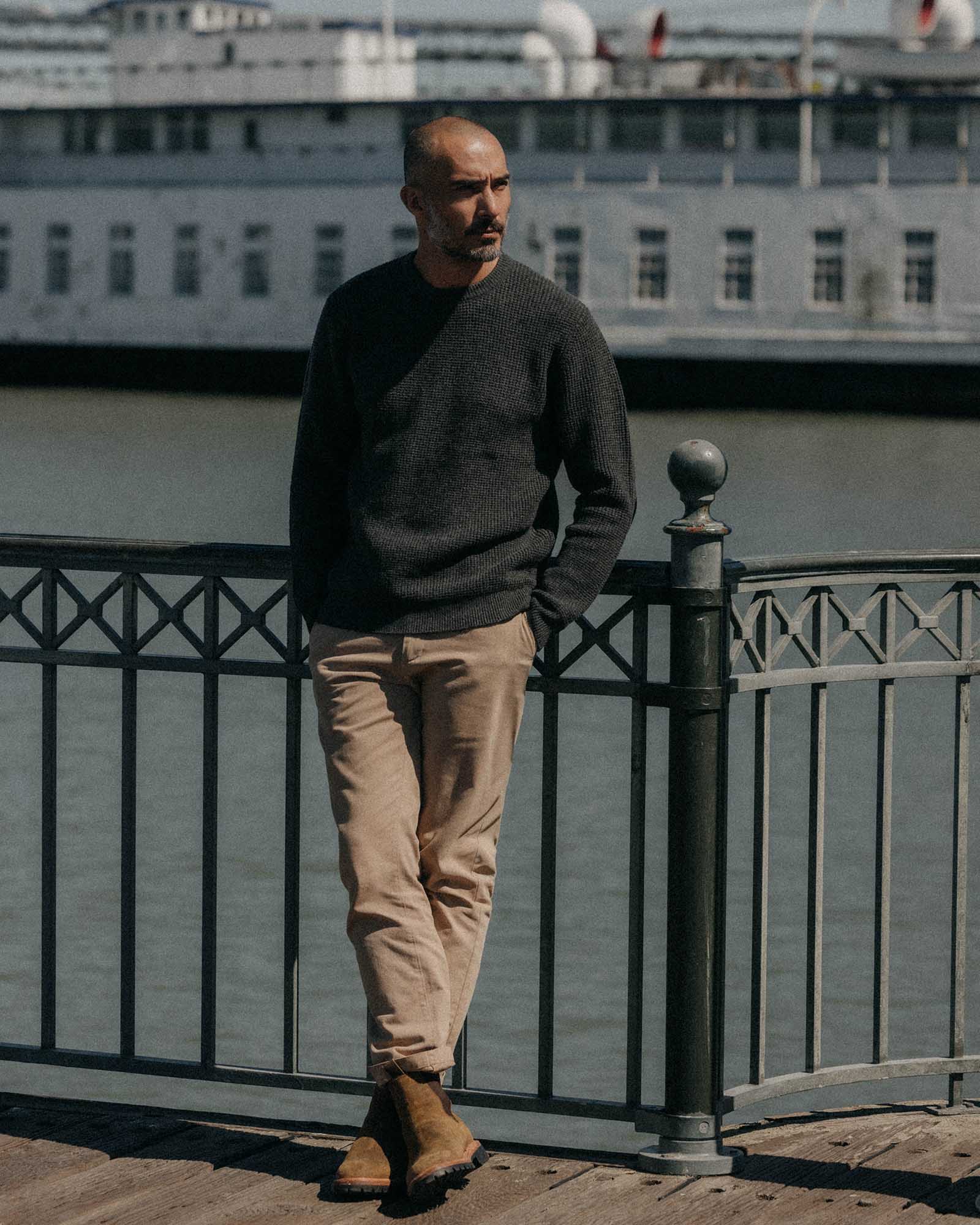 fit model leaning against the wall wearing The Sidecountry Crew in Heather Graphite Merino Waffle, Knits by Taylor Stitch