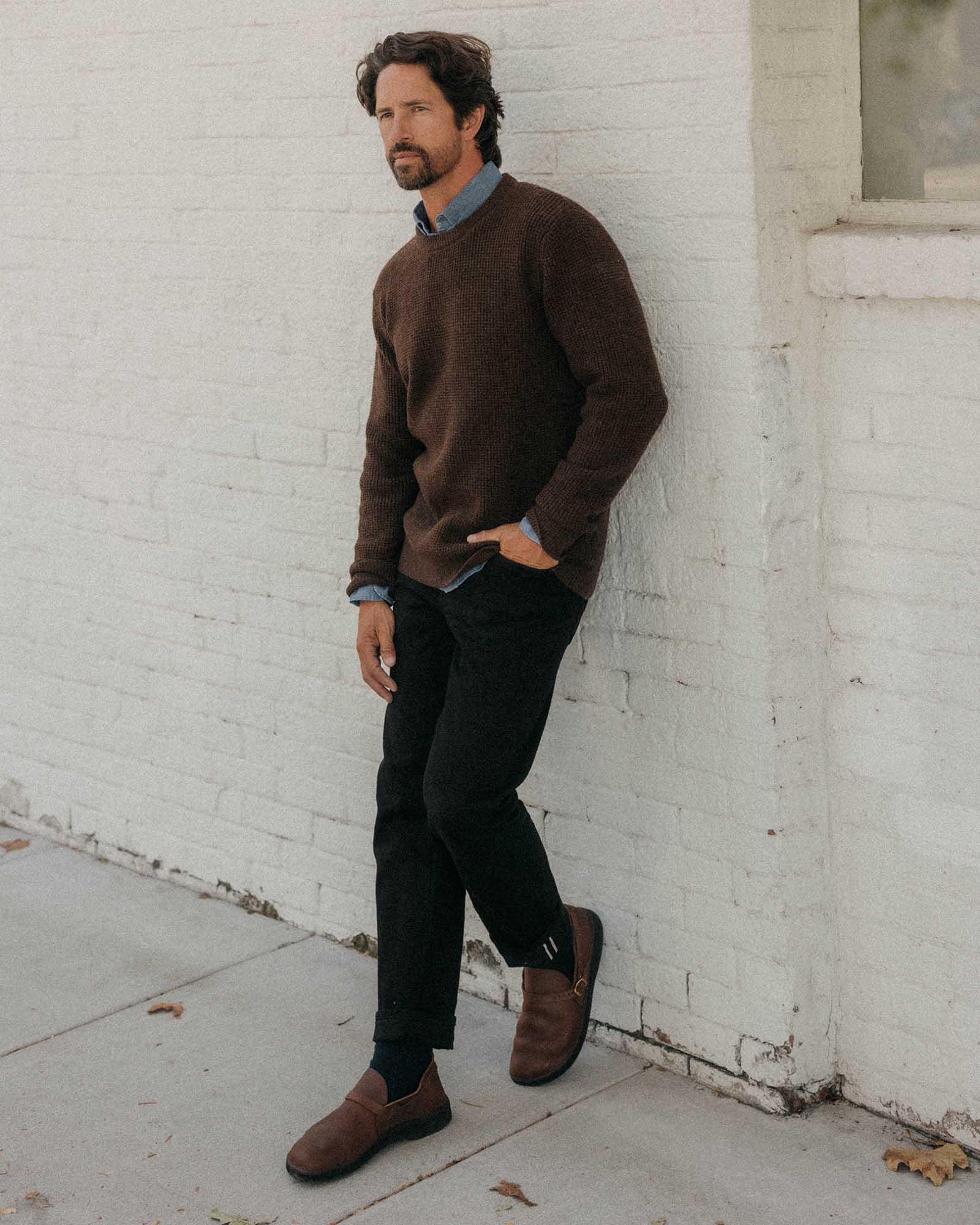 fit model leaning against the wall wearing The Sidecountry Crew in Heather Marsh Merino Waffle, Knits by Taylor Stitch