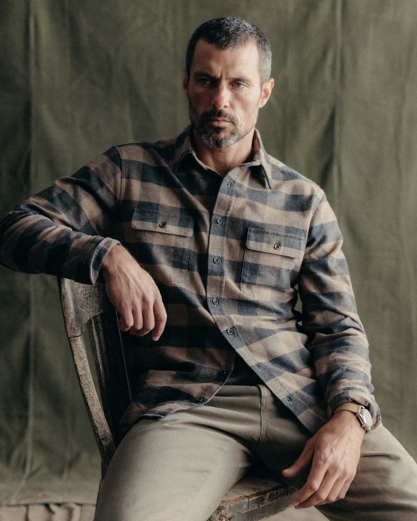 fit model sitting wearing The Yosemite Shirt in Heather Sable Buffalo Check, Wovens by Taylor Stitch