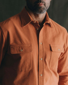 fit model showing off the pockets on The Yosemite Shirt in Summit Orange, Wovens by Taylor Stitch