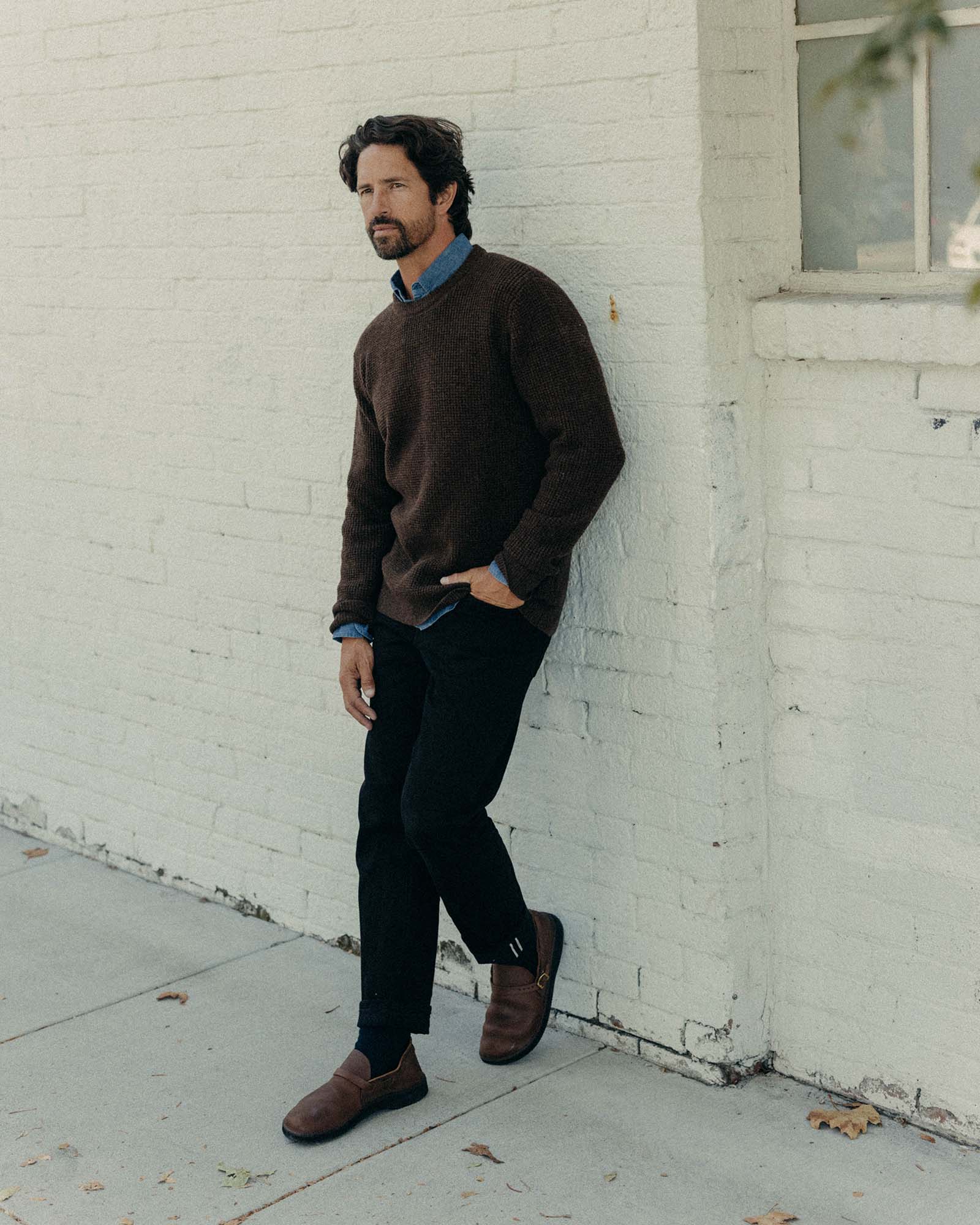 fit model showing off The Democratic Jean in Rigid Black Organic Selvedge, Bottoms by Taylor Stitch