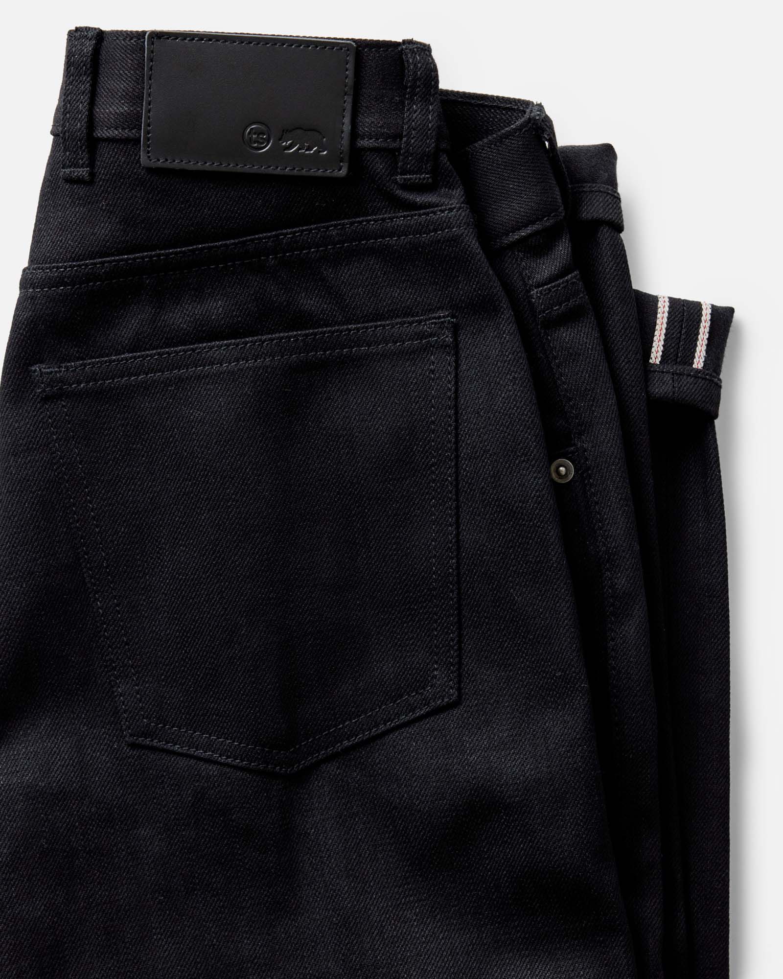 folded flatlay of the back of The Democratic Jean in Rigid Black Organic Selvedge, Bottoms by Taylor Stitch