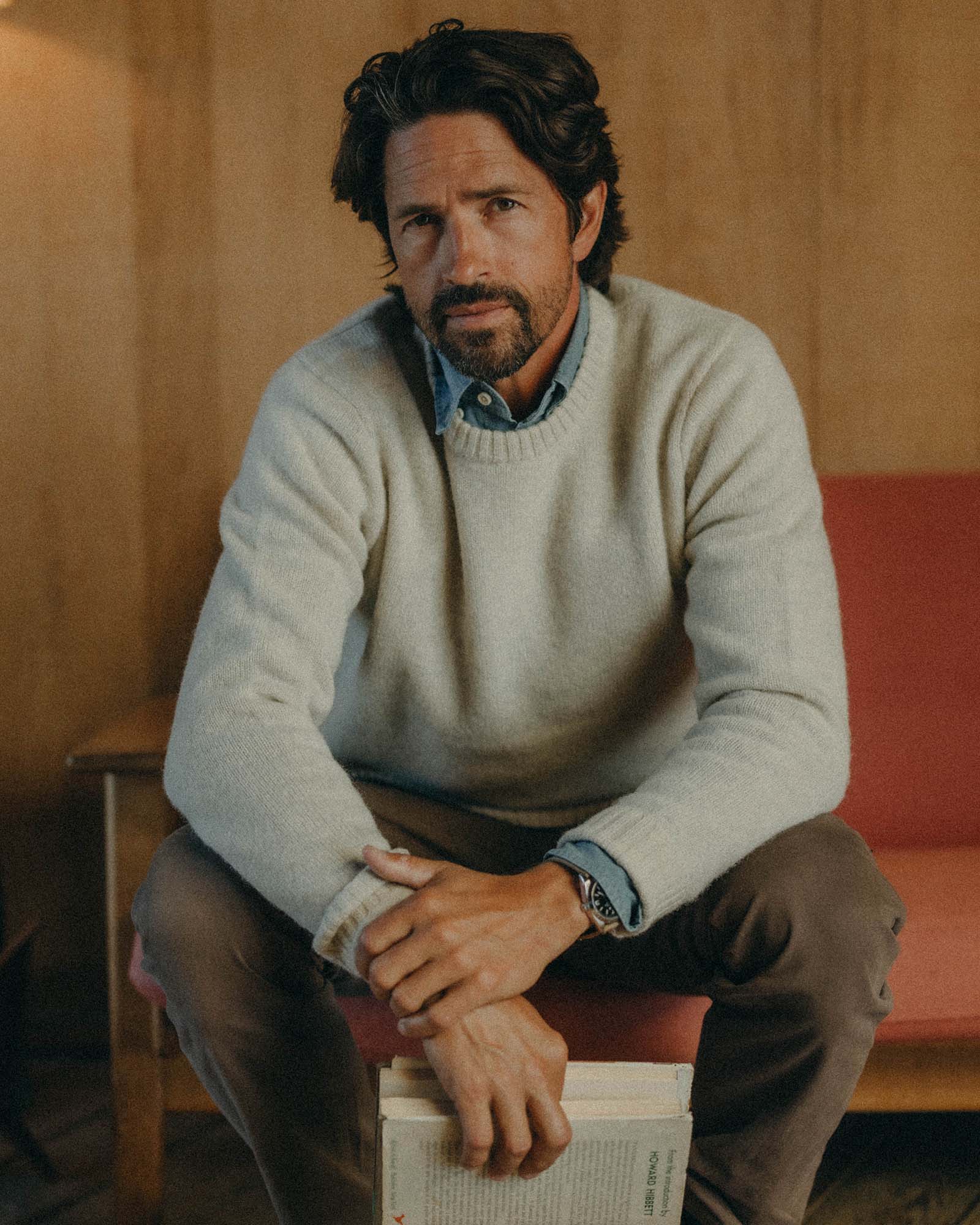 fit model sitting wearing The Eastmoor Sweater in Heather Ivory Wool, Knits by Taylor Stitch