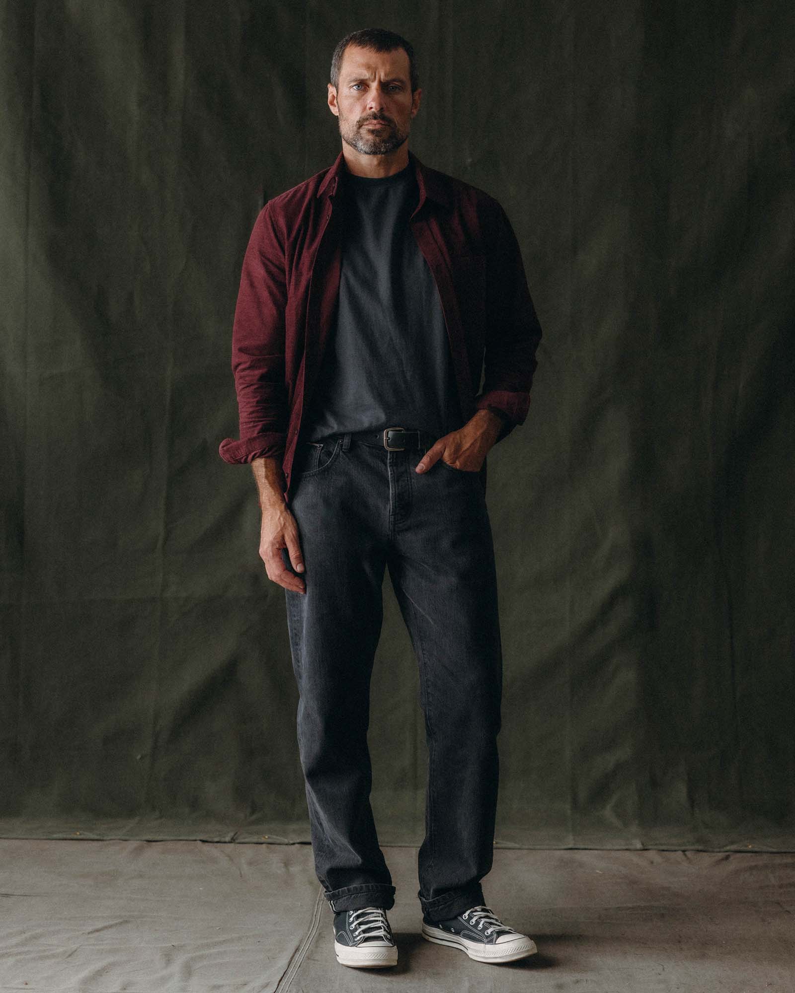 fit model with his hand in the pocket of The Jack in Heather Burgundy Pincord, Wovens by Taylor Stitch