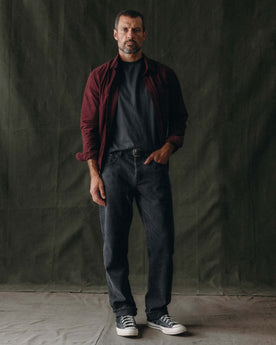 fit model with his hand in the pocket of The Jack in Heather Burgundy Pincord, Wovens by Taylor Stitch