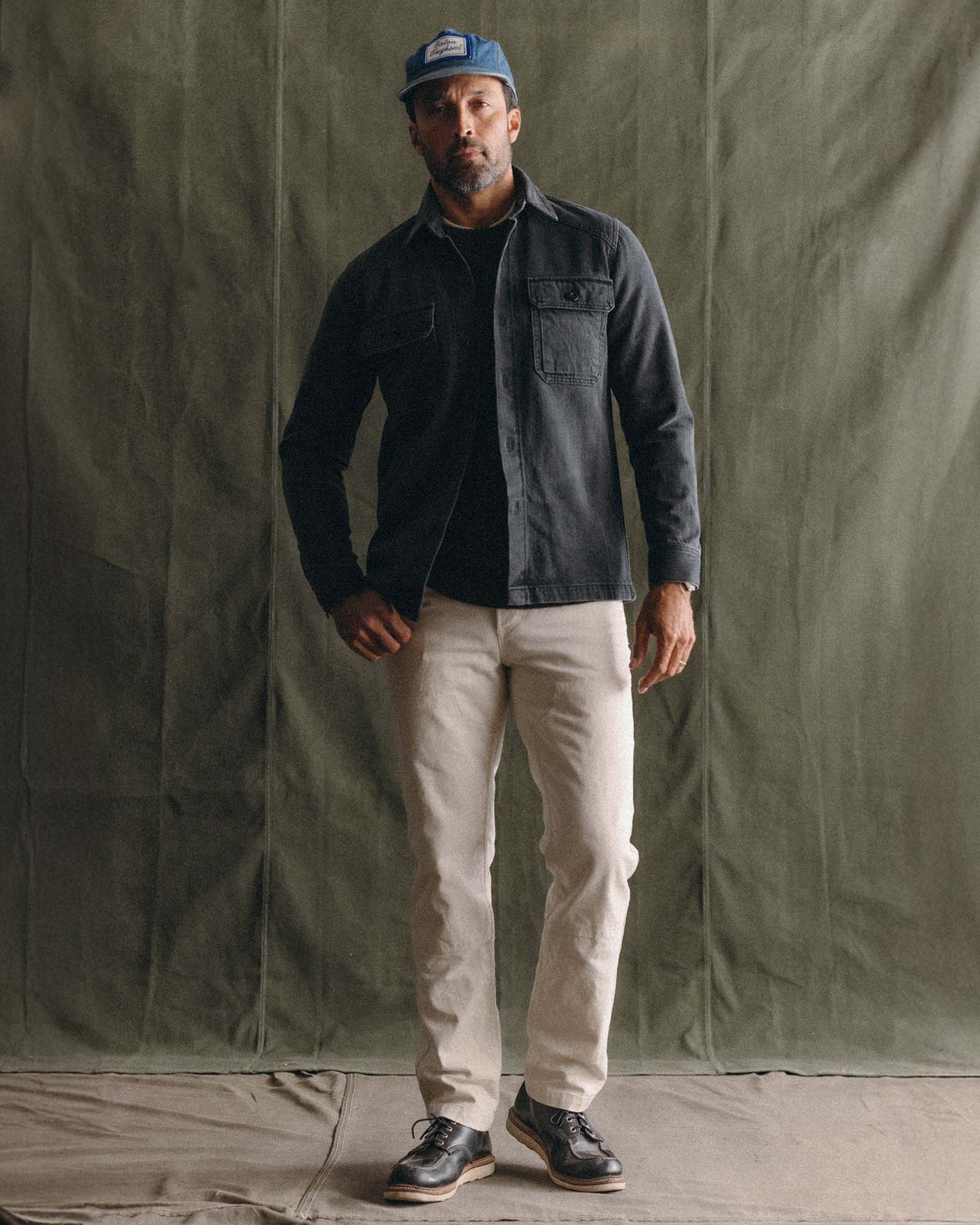 fit model posing in The Shop Shirt in Washed Black Organic Slub Selvedge, Wovens by Taylor Stitch