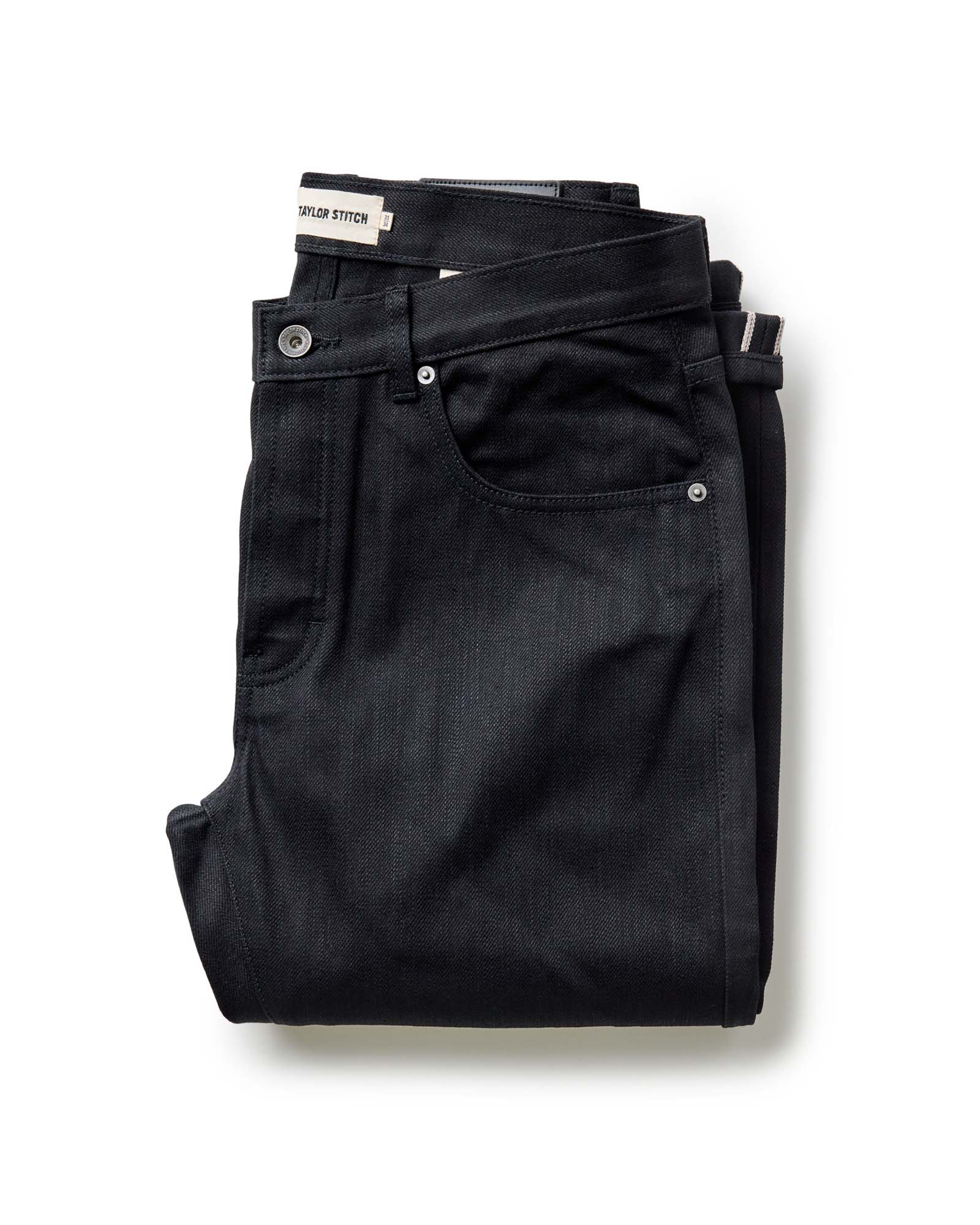 folded flatlay of The Slim Jean in Rigid Black Organic Selvedge, Bottoms by Taylor Stitch