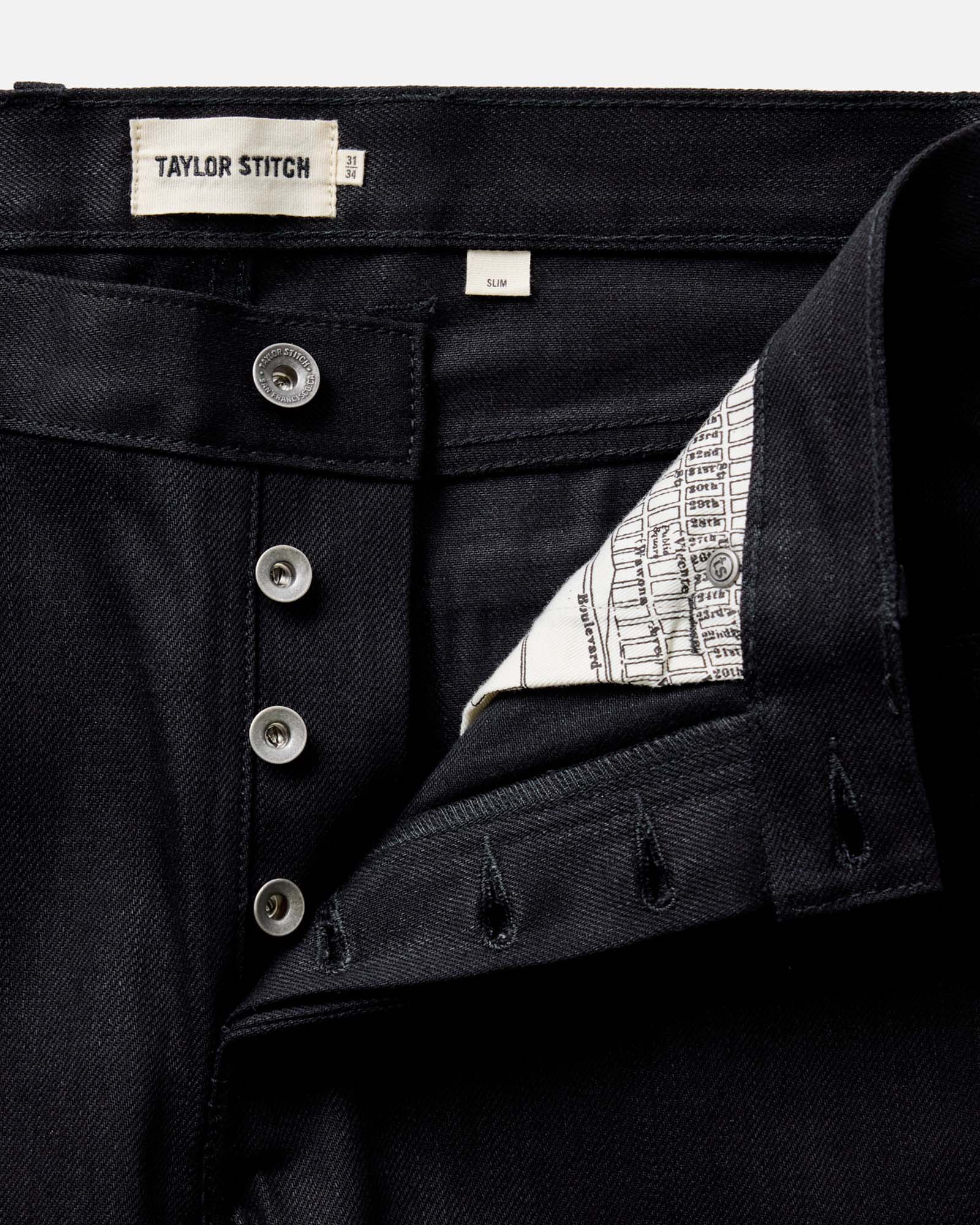 fit model walking wearing The Slim Jean in Rigid Black Organic Selvedge, Bottoms by Taylor Stitch