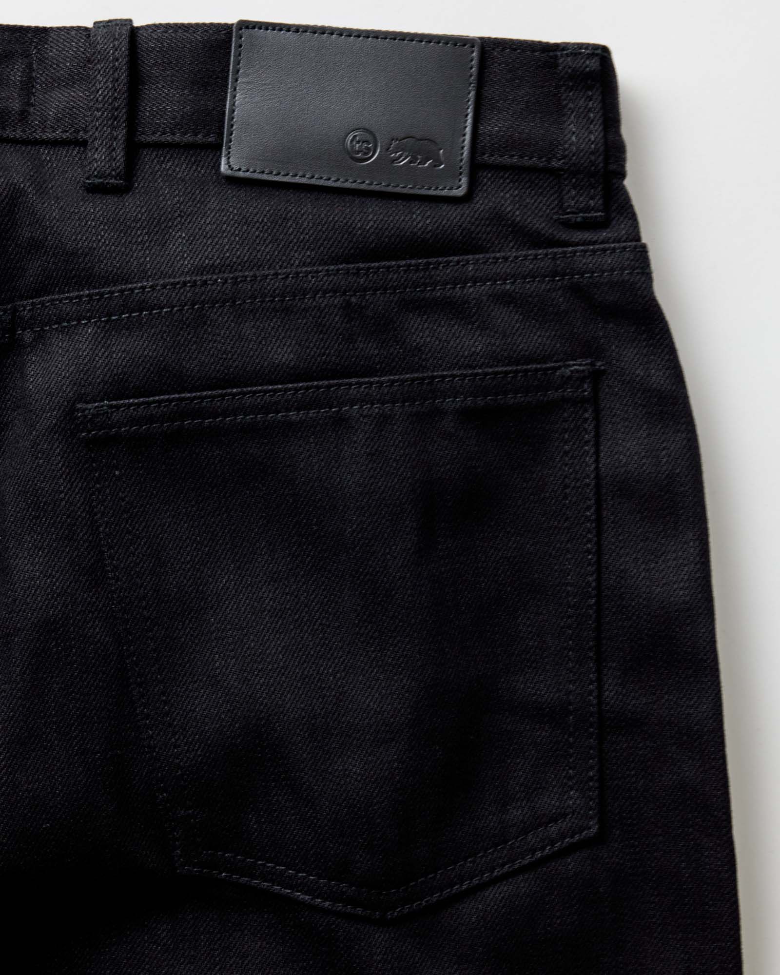 material shot of the button fly on The Slim Jean in Rigid Black Organic Selvedge, Bottoms by Taylor Stitch