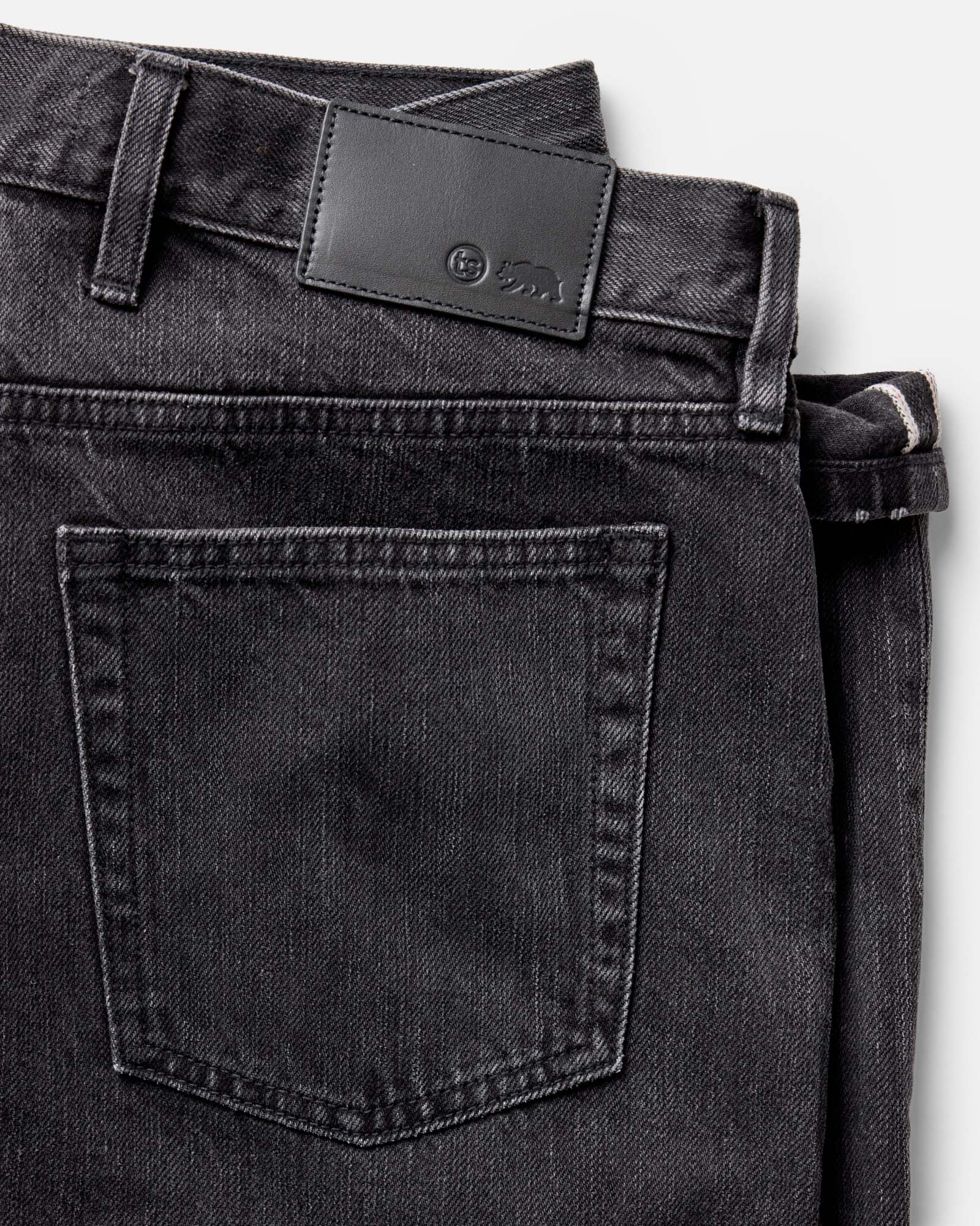 material shot of the back pocket on The Straight Jean in Washed Black Organic Slub Selvedge, Bottoms by Taylor Stitch