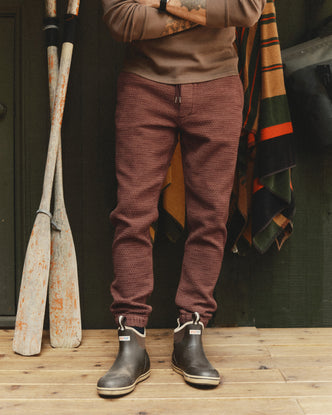 fit model walking with his hands in the pockets of The Apres Pant in Black Cherry Sashiko