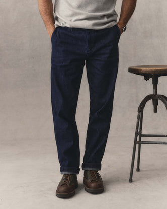 fit model with his hands in the pockets of The Camden Pant in Rinsed Indigo Roped Denim