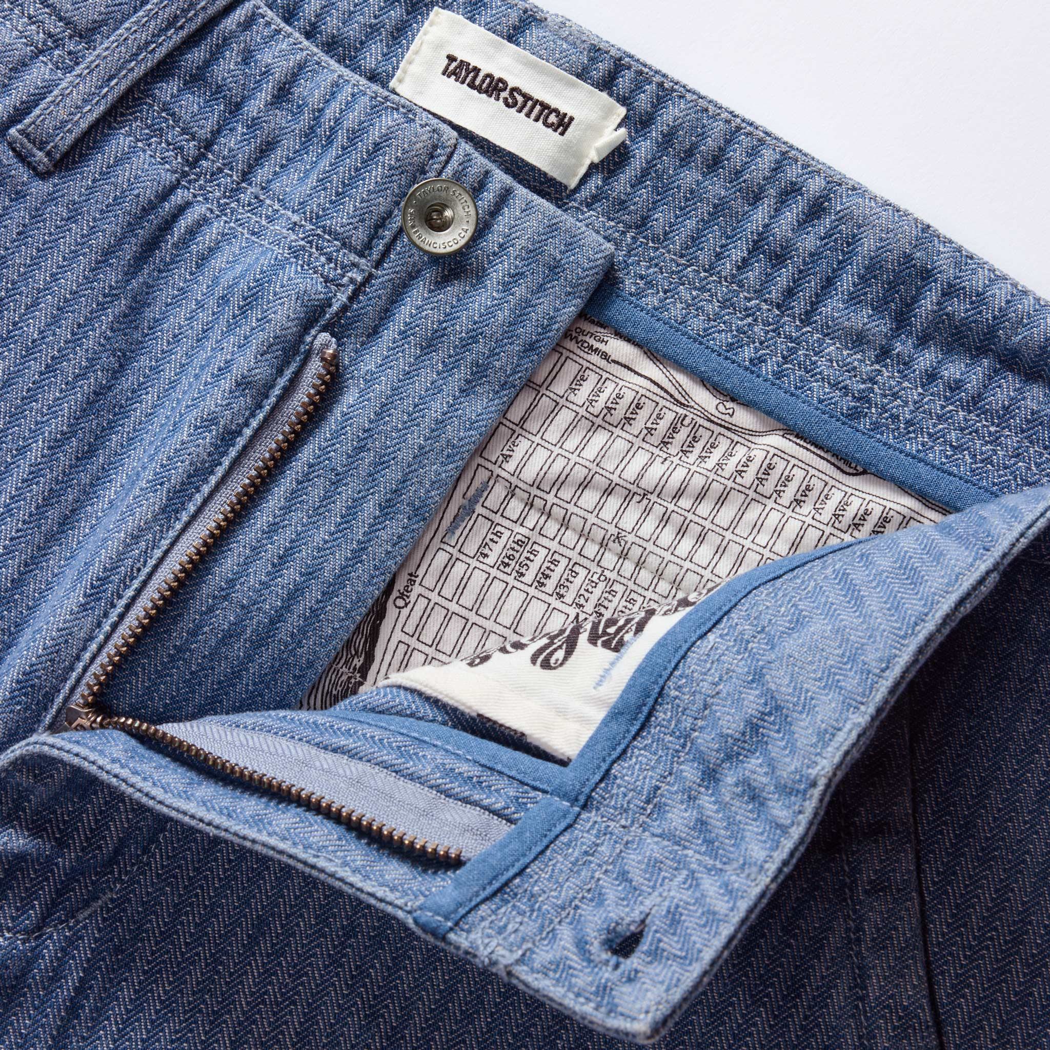 material shot of the zipper fly on The Morse Pant in Bleached Indigo Herringbone, Bottoms by Taylor Stitch