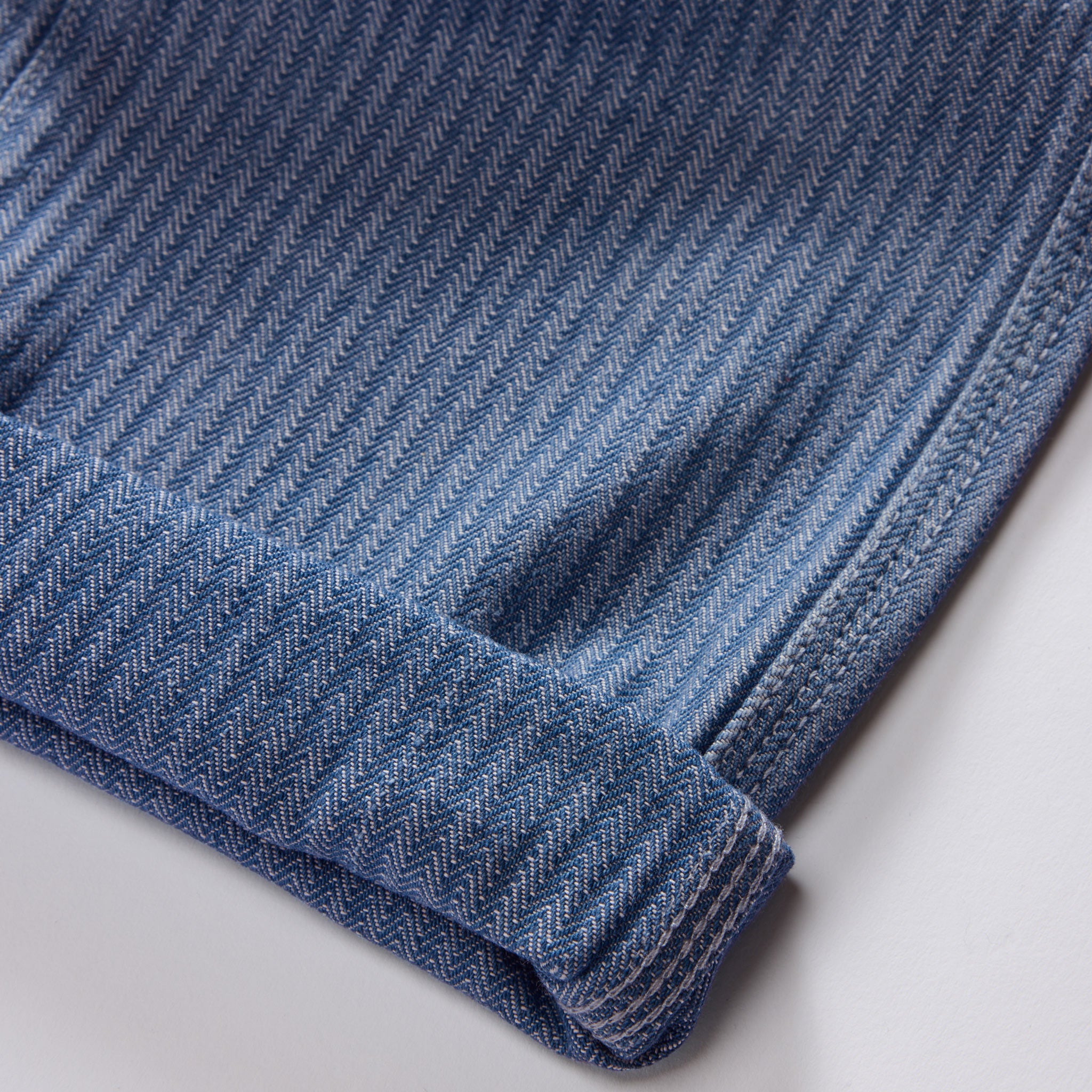 material shot of the cuffs on The Morse Pant in Bleached Indigo Herringbone, Bottoms by Taylor Stitch