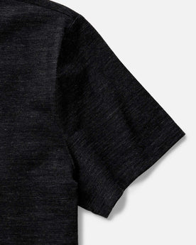 fit model sitting wearing The Merino Tee in Heather Black, Knits by Taylor Stitch