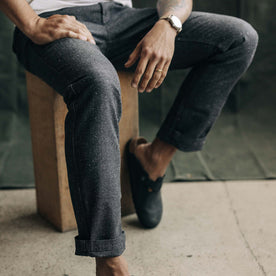 fit model sitting in The Carnegie Pant in Granite Herringbone