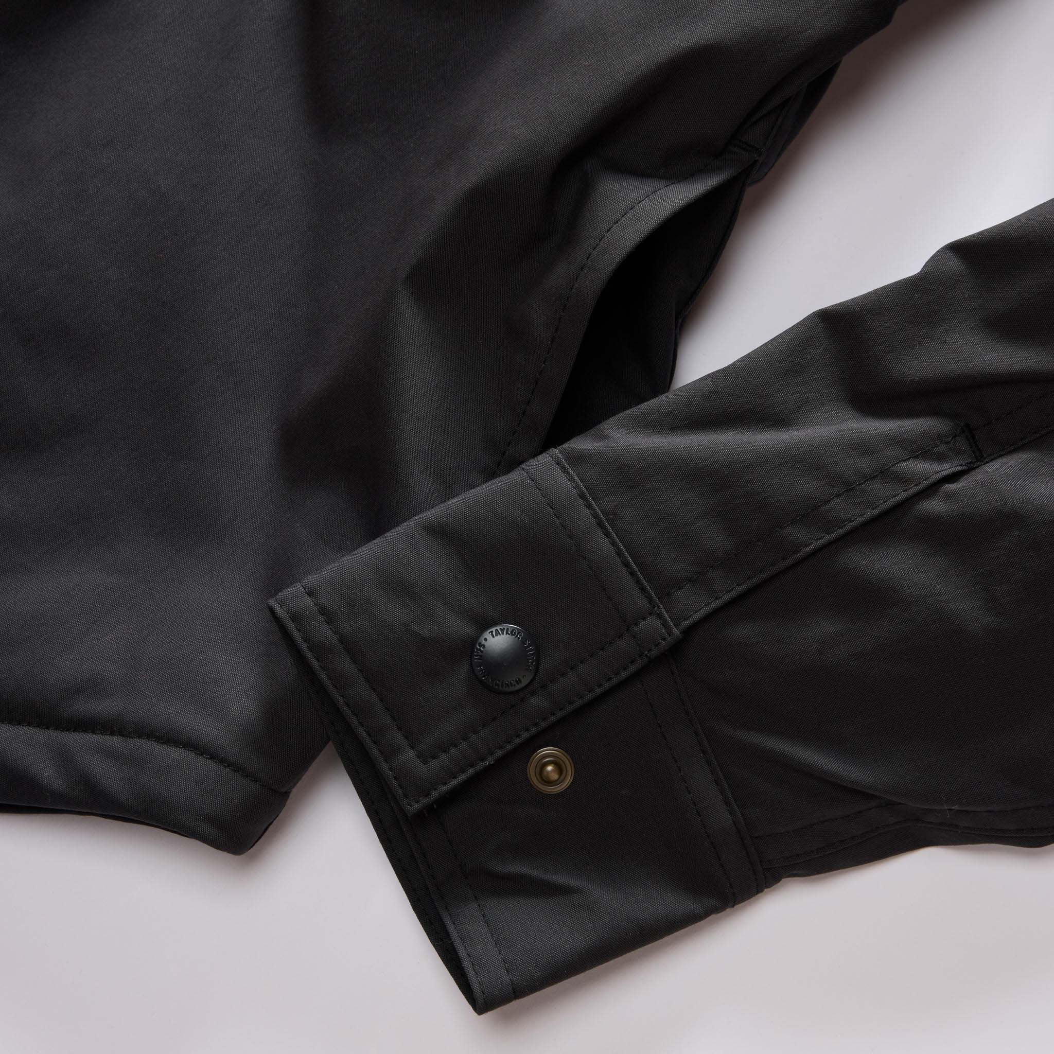material shot of the snap cuffs on The Lined Maritime Shirt Jacket in Coal, Wovens by Taylor Stitch