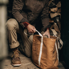 fit model placing logs into The Market Tote in Cedar Boss Duck