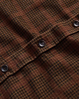 material shot of the buttons on The Saddler Shirt in Dark Roast Plaid Cord, Wovens by Taylor Stitch