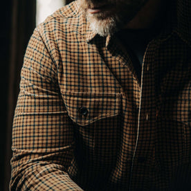 fit model showing the front flap pockets on The Saddler Shirt in Teak Plaid Cord