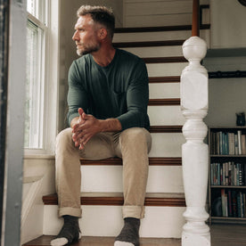 fit model sitting on stairs in The Slim All Day Pant in Light Khaki Cord