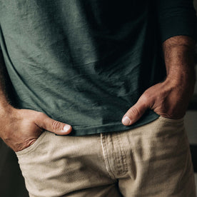 fit model with his hands in the pocket of The Slim All Day Pant in Light Khaki Cord