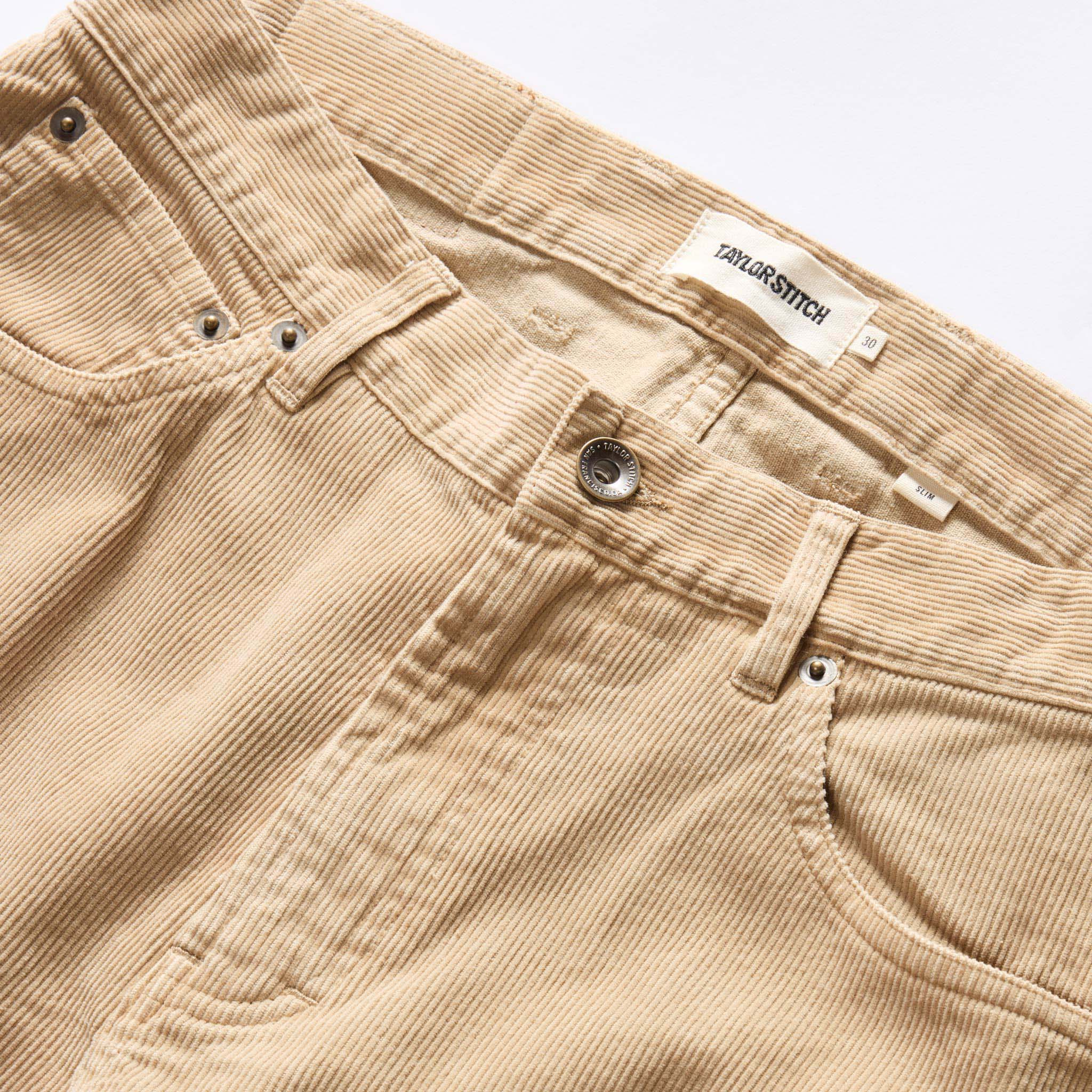 material shot of the button fly on The Slim All Day Pant in Light Khaki Cord, Bottoms by Taylor Stitch