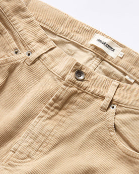 material shot of the button fly on The Slim All Day Pant in Light Khaki Cord, Bottoms by Taylor Stitch