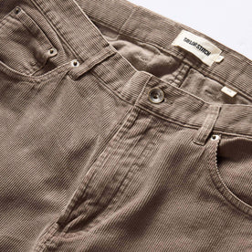 material shot of the button fly on The Slim All Day Pant in Morel Cord