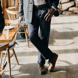 fit model crossing his legs in The Camp Pant in Navy Nep Wool