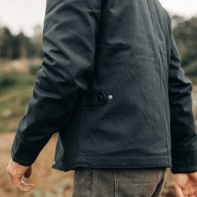 fit model showing the waist-level snap tab on The Deck Jacket in Dark Navy Dry Wax